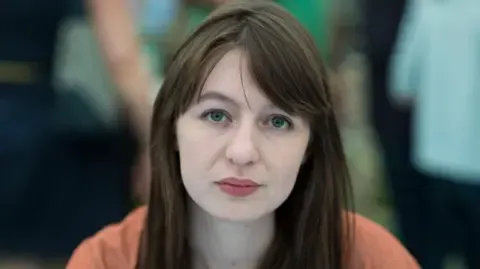 Sally Rooney declares she is unable to travel to the UK due to potential arrest